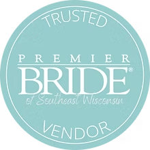 A teal circular badge with the words TRUSTED VENDOR around the edge and PREMIER BRIDE of Southeast Wisconsin in the center, indicating a trusted wedding vendor recognition.