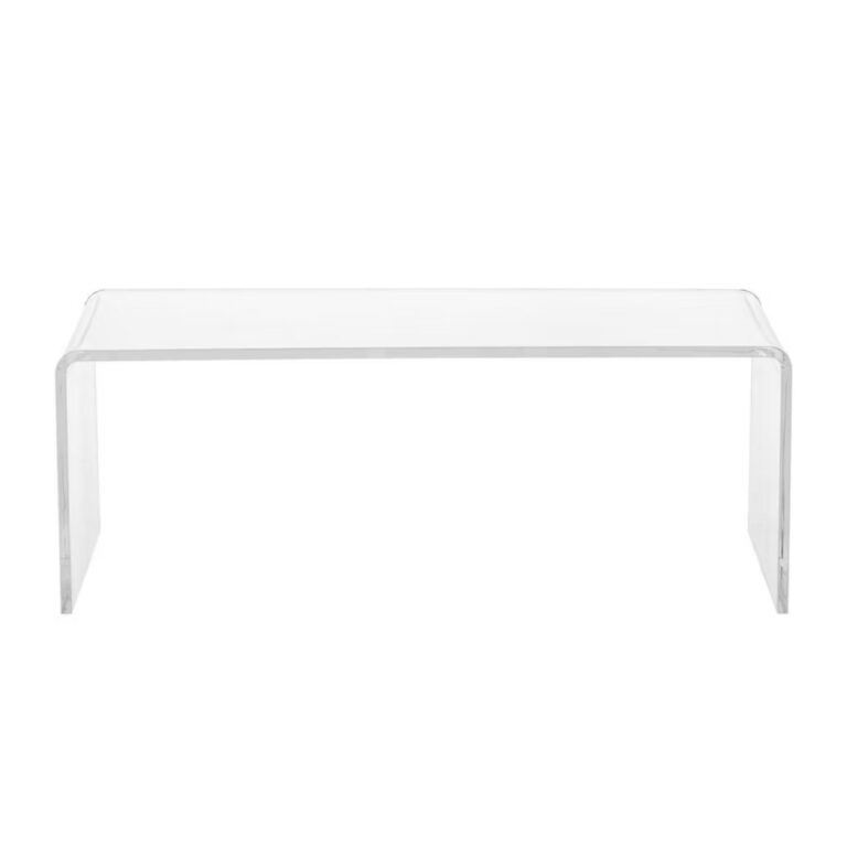 A minimalist, clear acrylic coffee table with a rectangular shape and rounded edges, designed in a single bent sheet with no visible joints or embellishments.