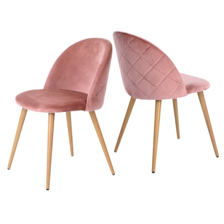 Two pink velvet dining chairs with light wooden legs. One chair is shown facing forward, while the other is angled to display the quilted diamond pattern on the backrest.
