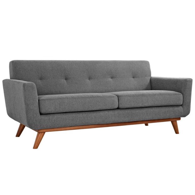 A modern, mid-century style gray fabric sofa with wooden legs, angled armrests, and a tufted backrest. The sofa seats three people and has a minimalist, clean design.