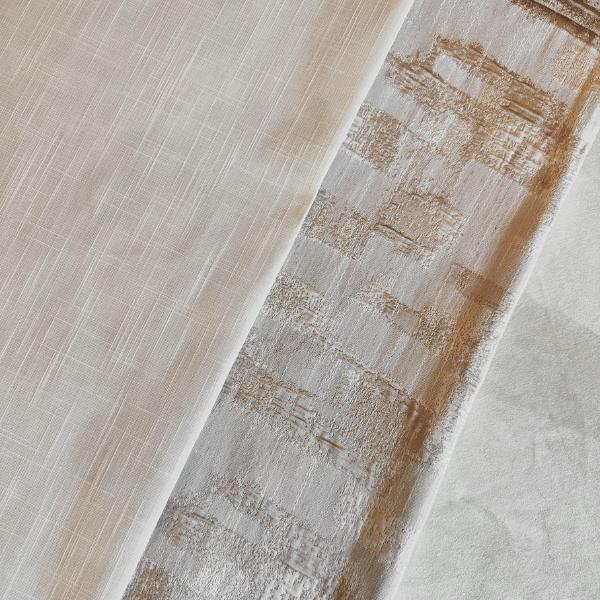 A close-up of three different white and beige fabrics with varying textures and patterns, including one with a grid-like weave and another with a slightly shiny, distressed geometric pattern.