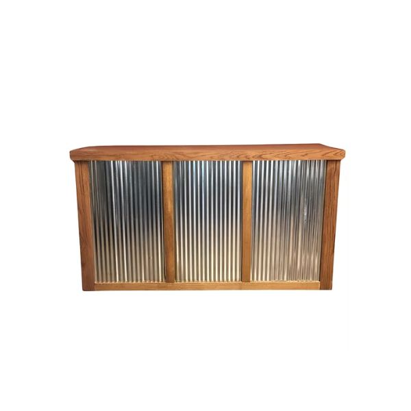 A bar counter with a corrugated metal front panel and a wooden top and frame, perfect for entertaining—pair it with rent tables, linens, or chairs for your holiday party. Photographed against a white background.