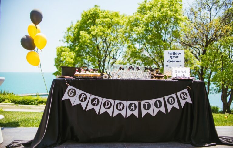A table with a sign on it, perfect for graduation party rentals.